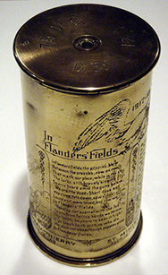 Shell IN FLANDERS' FIELDS engraved with John McCrae's poem on the left.