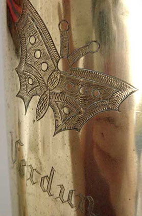 Pair of shells with irises, butterflies and VERDUN engraved in Gothic script.