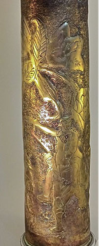 A jubilant Poilu is carried over a comrade's shoulder and pointing towards a Gallic Rooster perched on a 75 Field gun