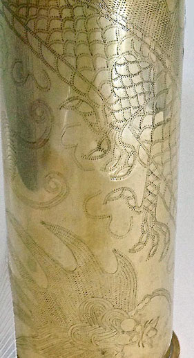 Shell engraved in zigzag work. Details of back legs claws and huge stylized beetle