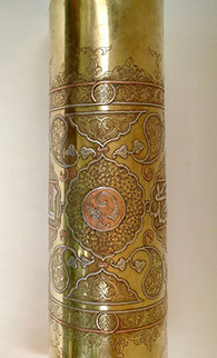 Shell highly decorated in Damascene work of inlaid copper and silver.