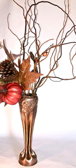 Shell with eight long flutes and a bulbous top embossed with daisies. Bouquet of fall dry flowers.