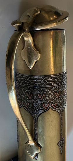 Shell with lid and handle. Upper decorative band inlaid in silver for the vines and copper for the grapes. Bezalel oval stamp at bottom.