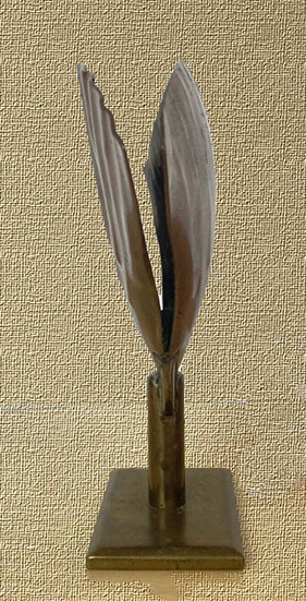 One side is flatter and ondulated. The other side is concave. Height 4 3/4"