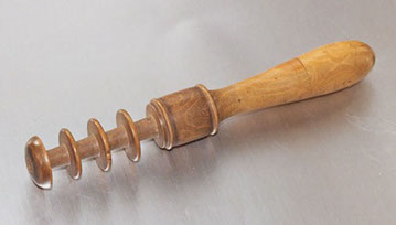 Tool in yew with space for four treads to be rolled in. Top unscrews and stocks needles. Mends shoes and occasionally engraves shells.