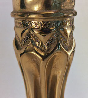 Shells fluted . Detail of spoked wheel punch pattern on a zig-zag band, an upper band, and triangles.