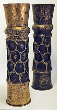 Pair of shells with honeycombed body, traces of dark paint, one with patina, the other polished.