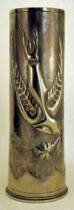 Shell with swallow&nbsp; bringing&nbsp; a flower. Wings are embossed with varous sizes punches.Serrated scalloped bottom band.