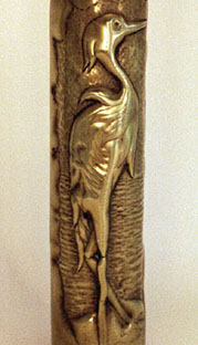 Shell presenting a scalloped frame with a heron on a marshland. Engraved VERDUN on the lower band.
