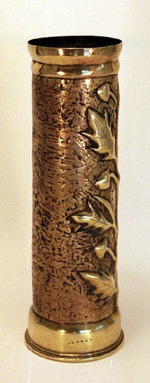 Shel with an oak branch with acorns embossed on a stippled background. Top and bottom slightly&nbsp; flared.