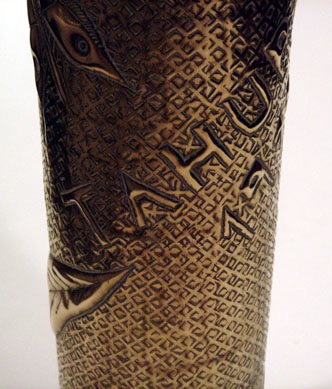 Shell embossed town of Tahure from the stems of letters from Champagne. Background of squares with central dots.