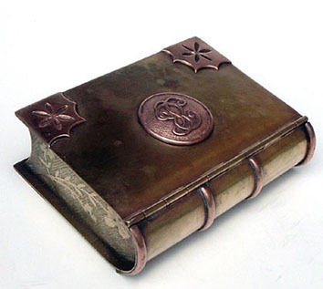 Jewel box in the shape of a book. Four copper raised bands on the spine. Regular hinges for the lid.
