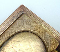 Jewel box opened. Details of the lid&nbsp; with zig-zag engraving around oval slot for picture.